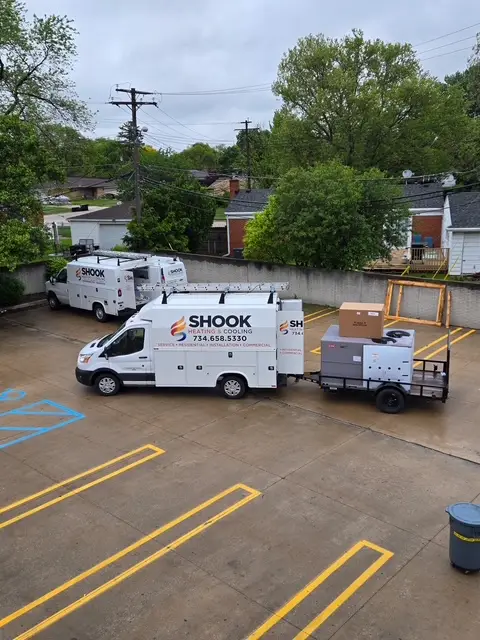Shook team hauling a commercial rooftop a/c unit to a customer commercial location for a/c installation